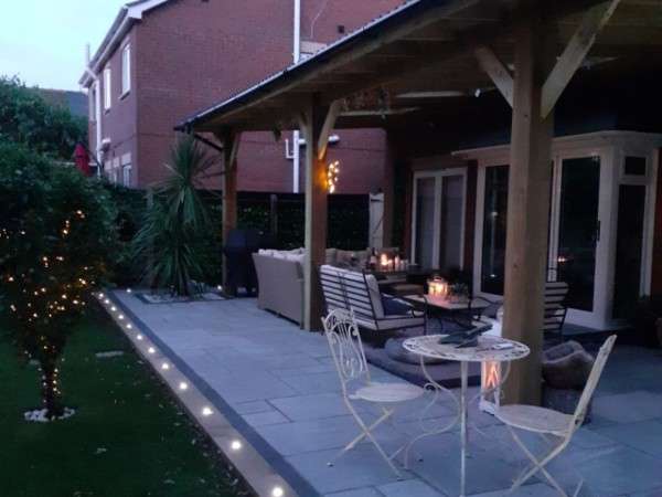 Luxury garden patio with covered seating area, paving and lighting installed by Kaye & Co Construction in Grimsby.